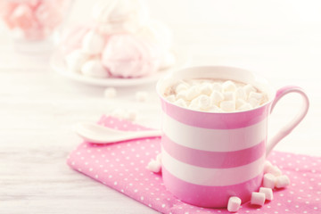 Obraz na płótnie Canvas Mug of hot chocolate with marshmallows, on light wooden background