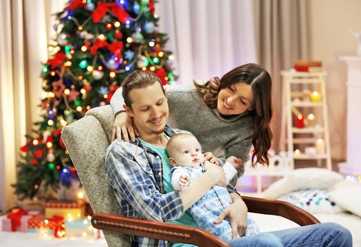 Christmas concept: happy family in decorated room