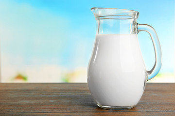 Jar of milk on blurred natural background