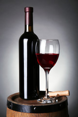 Wine on barrel on dark background