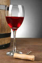 Wine in barrel and in glass on table