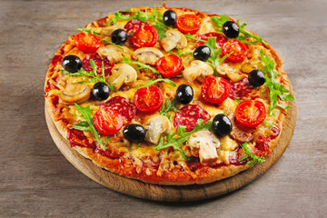 Delicious tasty pizza on wooden table