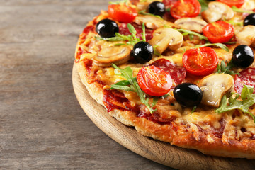 Delicious tasty pizza on wooden table