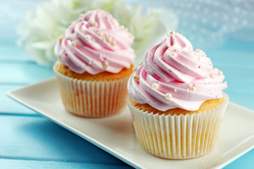 Pink cupcakes on wooden background