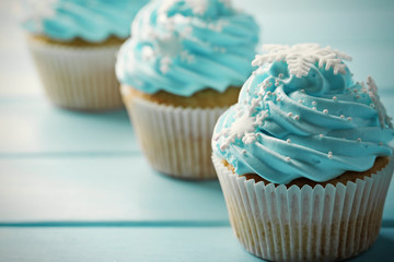 Blue cupcakes on wooden background