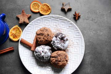 Chocolate balls with dried orange and cinnamon on table