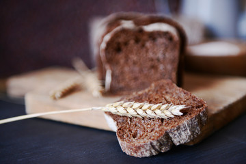 Sliced bread with ears on cutting board closeup