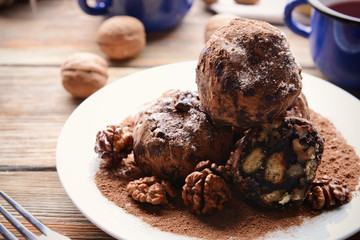 Chocolate sweets with spices on wooden table