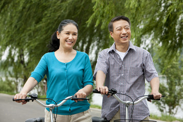 Senior couple cycling in park