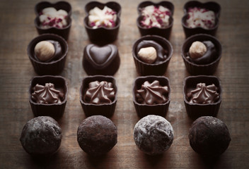 Set of chocolate candies on a wooden background