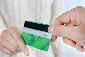 Hands holding a credit card