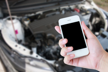 closeup of hand hold smartphone with broken car