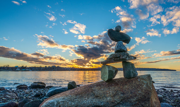 inukshuk in the sunset on the beach