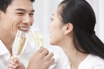 Happy young couple drinking champagne