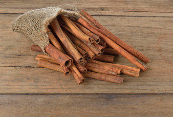 Cinnamon sticks on wooden background