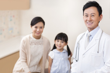 Doctor with girl and young mother in hospital