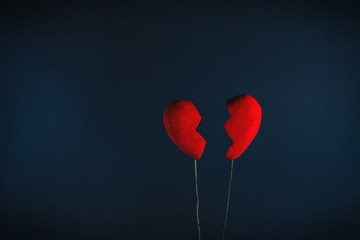 Conceptual of broken heart on the dark blue background.