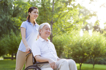 Wheelchair bound man with nursing assistant