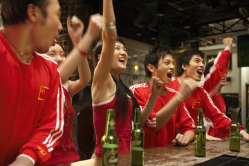 Patriotic Young People In A Bar Celebrating Win