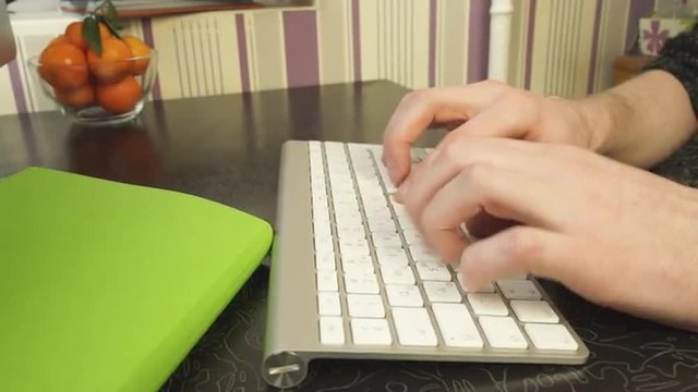 The man quickly typing on the keyboard.