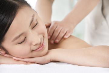 Close up of a young woman getting a massage