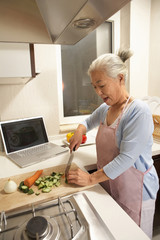 Elderly Woman In The Kitchen