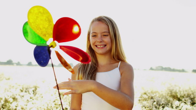 Young Caucasian Girl Playing Outdoors Toy Windmill Clean Environmental Energy