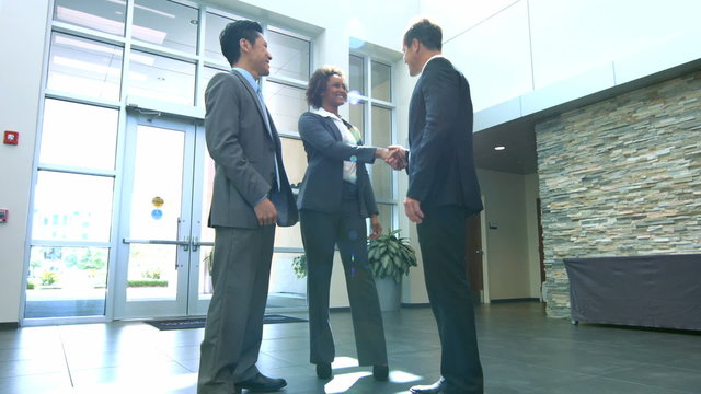 Multi ethnic male female business team meeting handshake