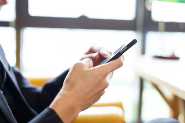people playing with cell phone in cafe