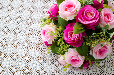 pink rose bouquet on white crochet tablecloth