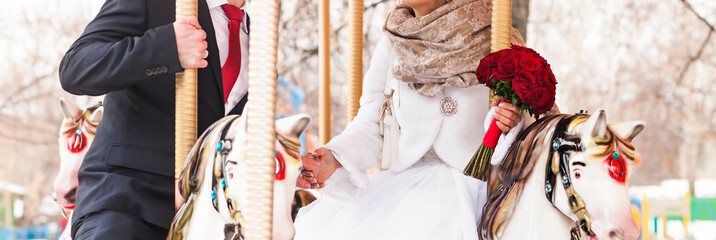 bride and groom in a carousel on their wedding day
