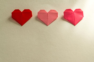 Origami paper hearts on a white background