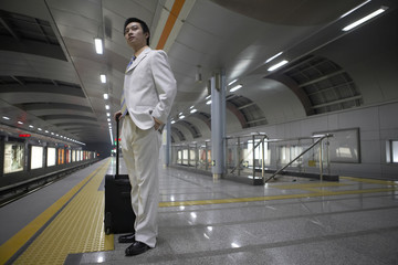 Chinese Male Waits Patiently For Subway Train To Arrive