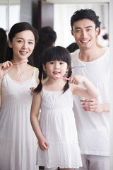 Happy family brushing teeth