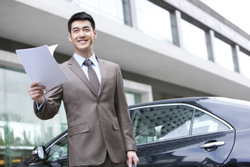 Fototapeta premium Young businessman reading file