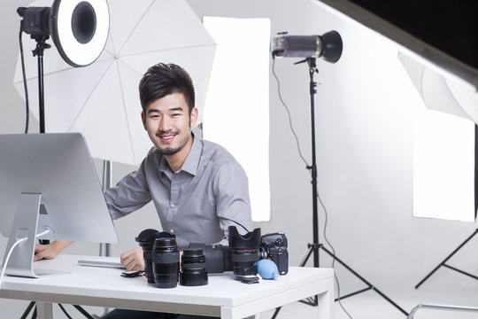 Portrait of smiling photographer working in studio