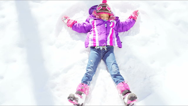 outdoor snow play young Caucasian girl active Colorado winter vacation tourism 