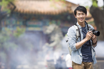 Portrait of man holding camera