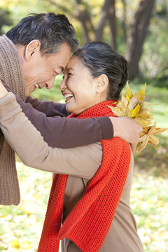 Senior couple smiling face to face in Autumn