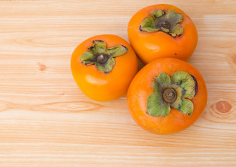 Persimmon on wood plate