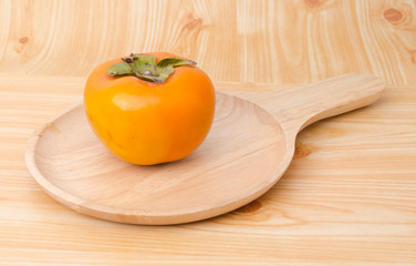 Persimmon on wood plate
