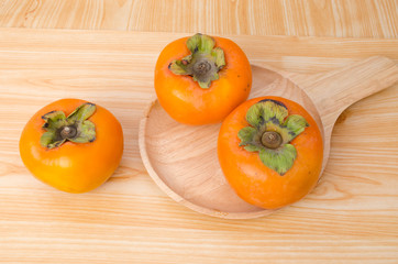 Persimmon on wood plate