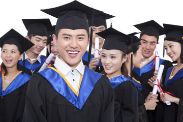 Portrait of graduates holding diploma 