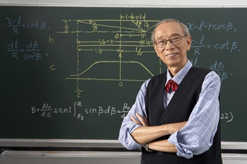 Teacher Standing In Front Of Blackboard