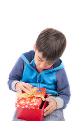 Little boy opening gift present box on white background