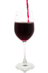 pouring red wine from bottle in the glass