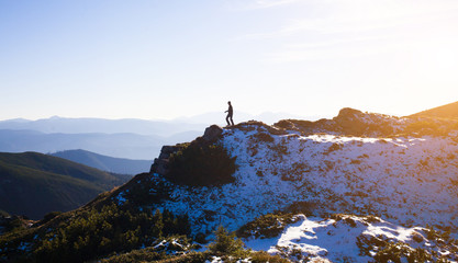 Silhouette of a climber on a mountain ridge.