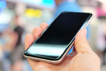 Close up of using smart phone at the airport.