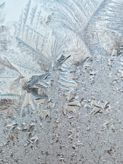 Ice floral pattern on glass in blurred vignette. Macro view. Holiday seasonal background
