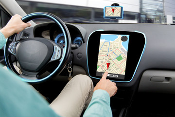 close up of man driving car and using navigator